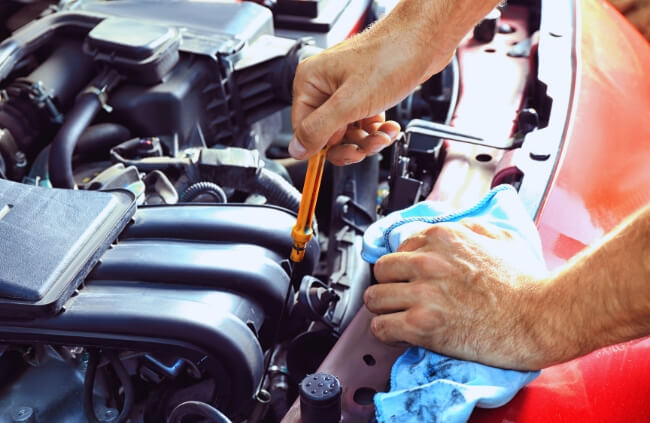 A mobile mechanic checking oil levels as part of expert car servicing by True Blue Mobile Mechanics Sydney. Trusted for logbook servicing and mobile car service Penrith wide