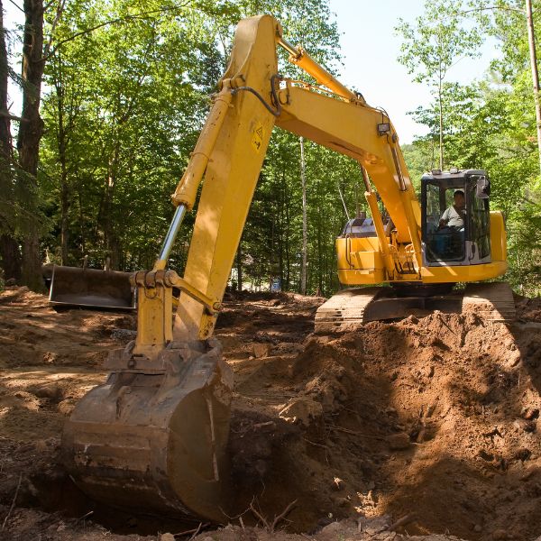 Heavy machinery carrying out bulk excavation for site preparation on a rural block by Rural Property Services NSW