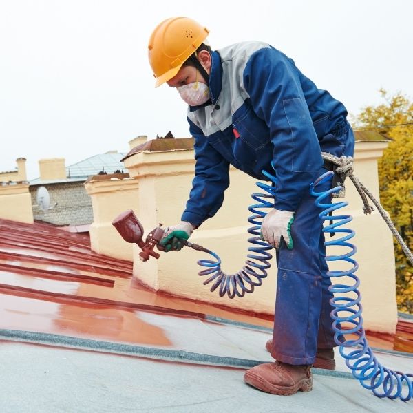 Roofing Guys Sydney roof painter applying durable paint finish on metal roof