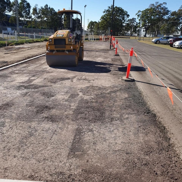 Commercial carpark preparation with roller compactor and gravel base by West Sydney Landscapes