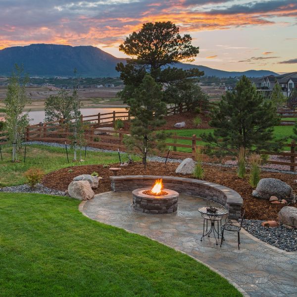 Complete fire pit area landscaping in Western Sydney with stone seating fire pit and garden features by West Sydney Landscapes